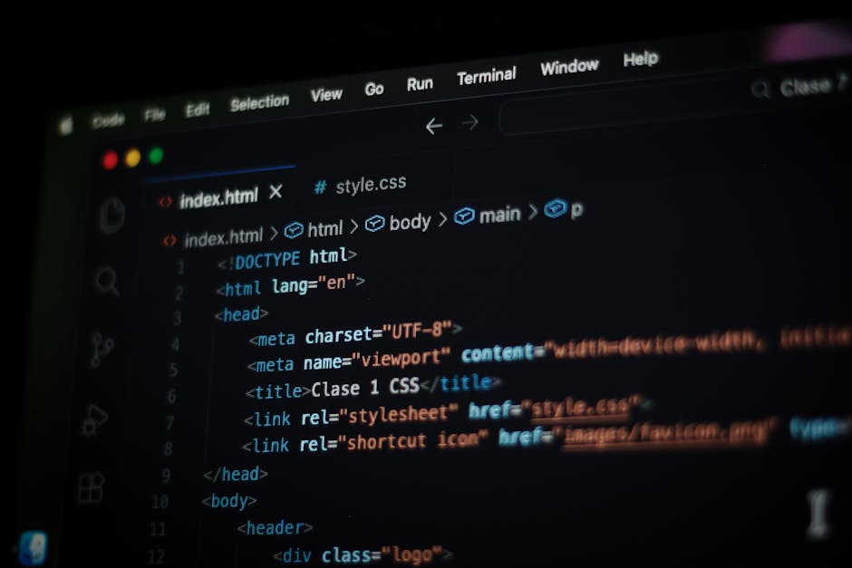 A close-up image of a computer screen displaying HTML and CSS code within a code editor interface. The screen shows lines of markup language including <html>, <head>, <title>, and <link> tags, with va